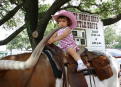 Graciela riding a Longhorn